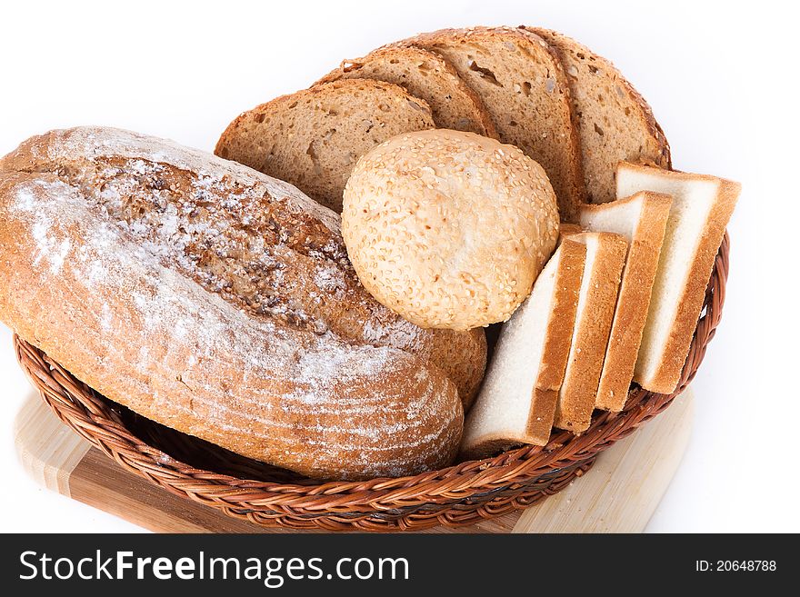 Various bakery products in a basket over white