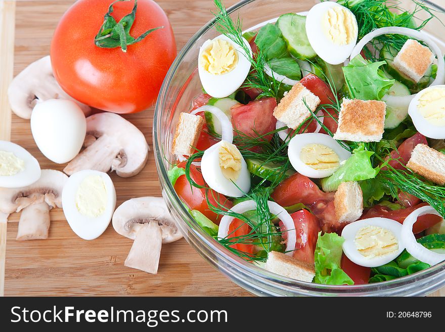 Fresh raw vegetable salad in glass bowl