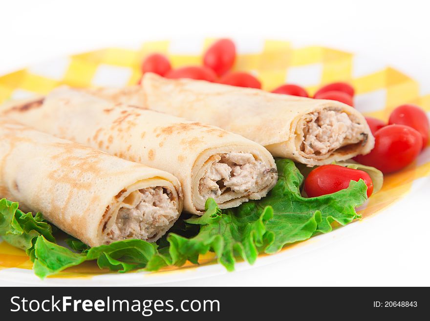 Pancakes with the chicken, lettuce, and tomatoes on the yellow plate