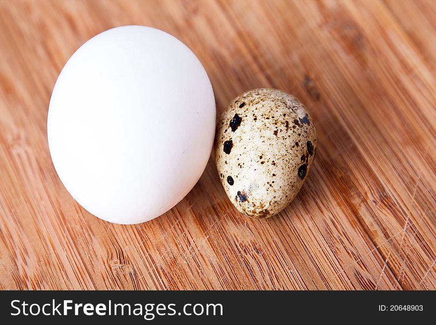 Two eggs on the wooden cutting board