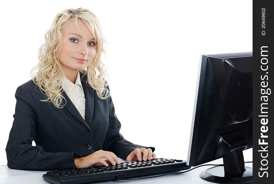 The young girl behind the computer on white