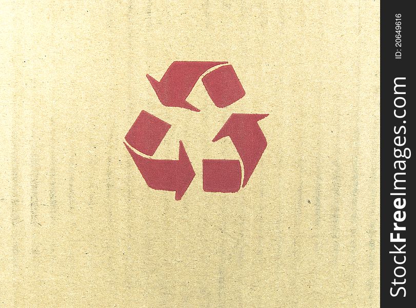 Red recycle symbol on cardboard.