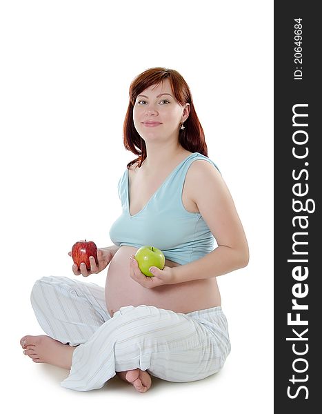 The pregnant woman with an apple on white