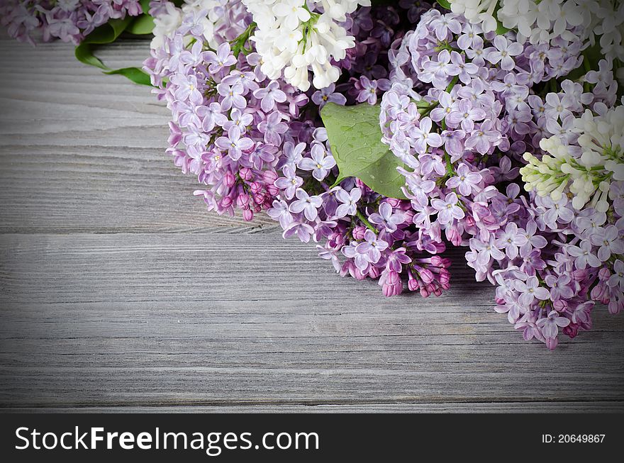 The beautiful lilac on a wooden surface