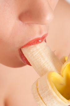 Young Woman Eating Banana Stock Image