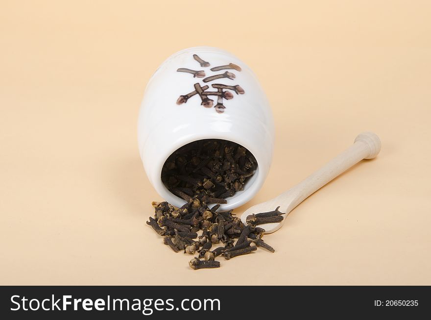 Seeds of cloves on beige background