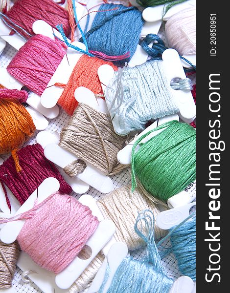 Pile Of Coloured Bobbins Of Thread