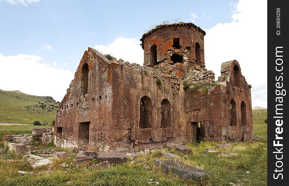 Landscape ruins of dilapidated and derelict Old Red Church Kizil Kilsie Cappadocia Turkey dating to the 6th century, red limestone, horizontal, crop area and copy space. Landscape ruins of dilapidated and derelict Old Red Church Kizil Kilsie Cappadocia Turkey dating to the 6th century, red limestone, horizontal, crop area and copy space