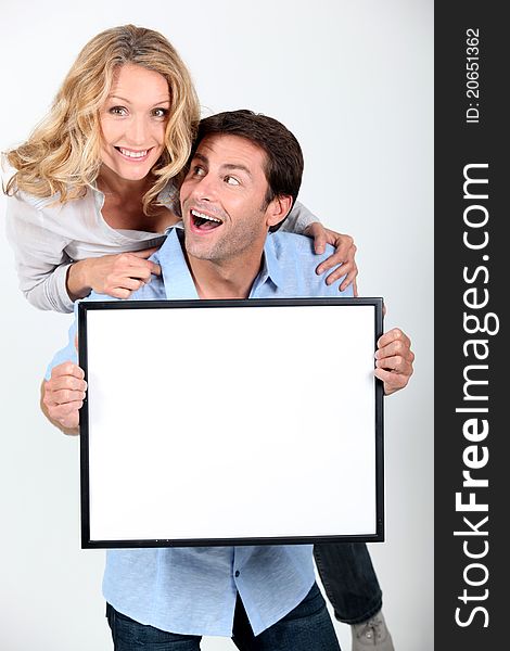 Enthusiastic couple with white board