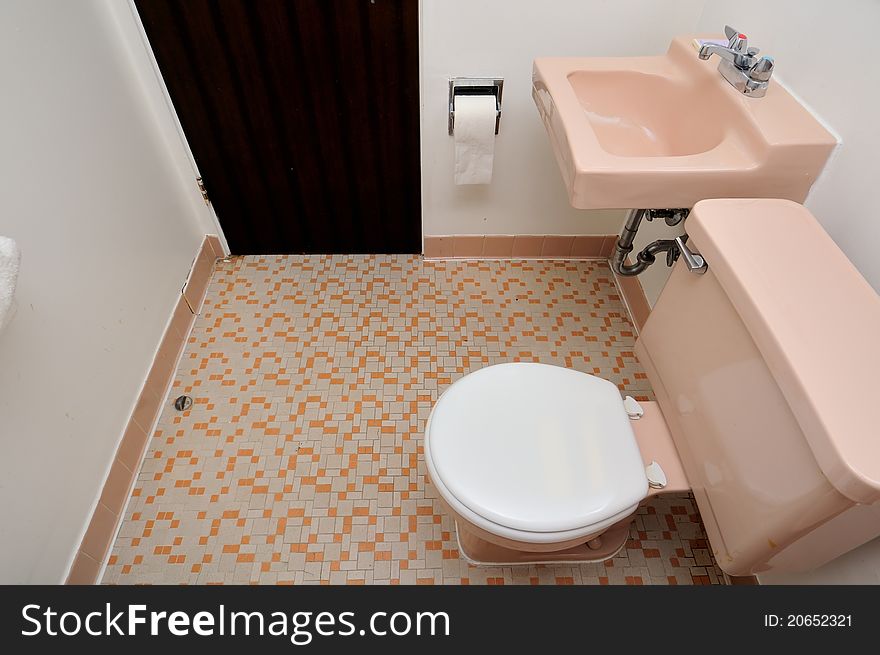 Simple and ordinary toilet and wash basin at the side. Simple and ordinary toilet and wash basin at the side.