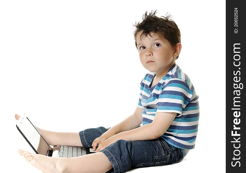 Lovely child isolated on a white background with a laptop. Lovely child isolated on a white background with a laptop