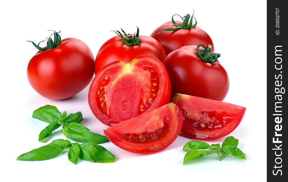 Red tomatoes with basil on a white background