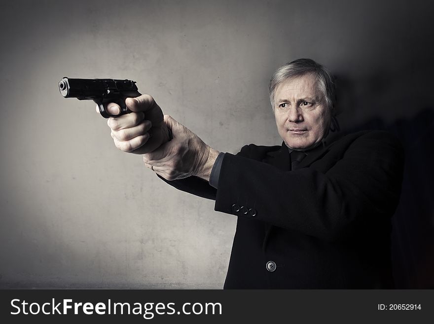 Portrait of a senior man holding a gun. Portrait of a senior man holding a gun