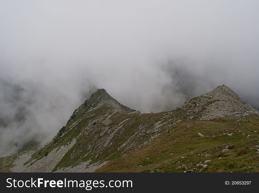 Path and hikers on the ridge of a mountain in Transylvania. Path and hikers on the ridge of a mountain in Transylvania