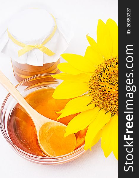 Honey in jar with wooden spoon and sunflower. Honey in jar with wooden spoon and sunflower