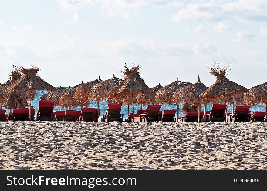 View of the beach with loungers and umbrellas. View of the beach with loungers and umbrellas.