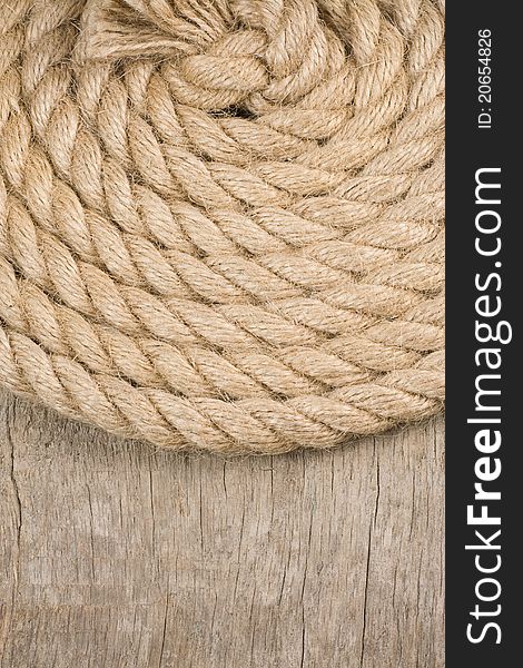 Ship ropes and knot on wood background texture. Ship ropes and knot on wood background texture