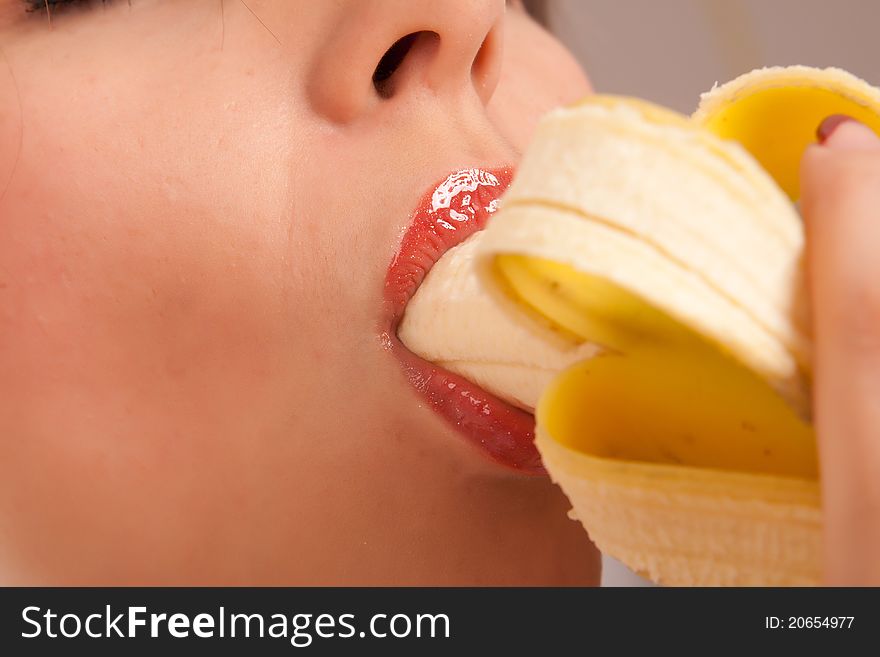 Young Woman Eating Banana