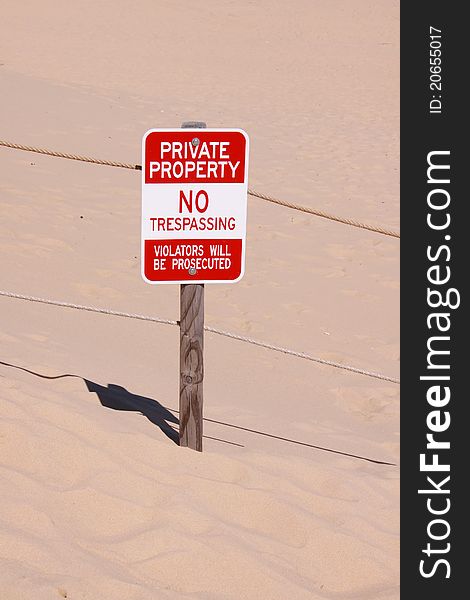 Single Private property board in the middle of sand dunes