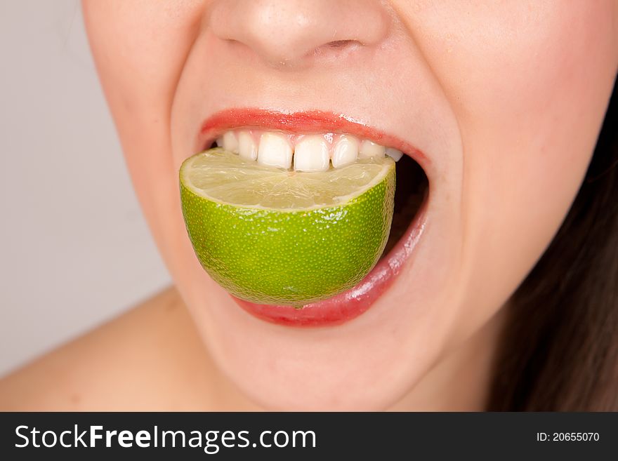 Girl biting lime