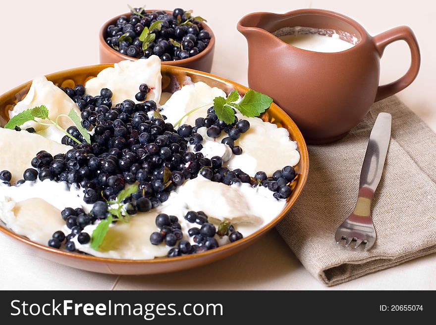 Sweet and delicious dumplings with cottage cheese, sour cream and berries. Sweet and delicious dumplings with cottage cheese, sour cream and berries