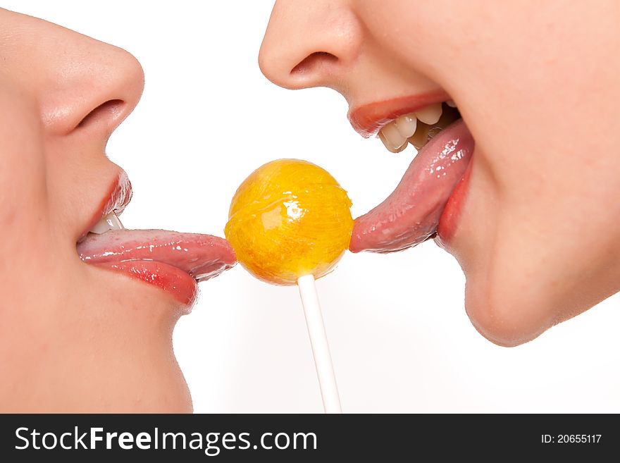 Two Sweet Female Models Kissing Through Lollipop