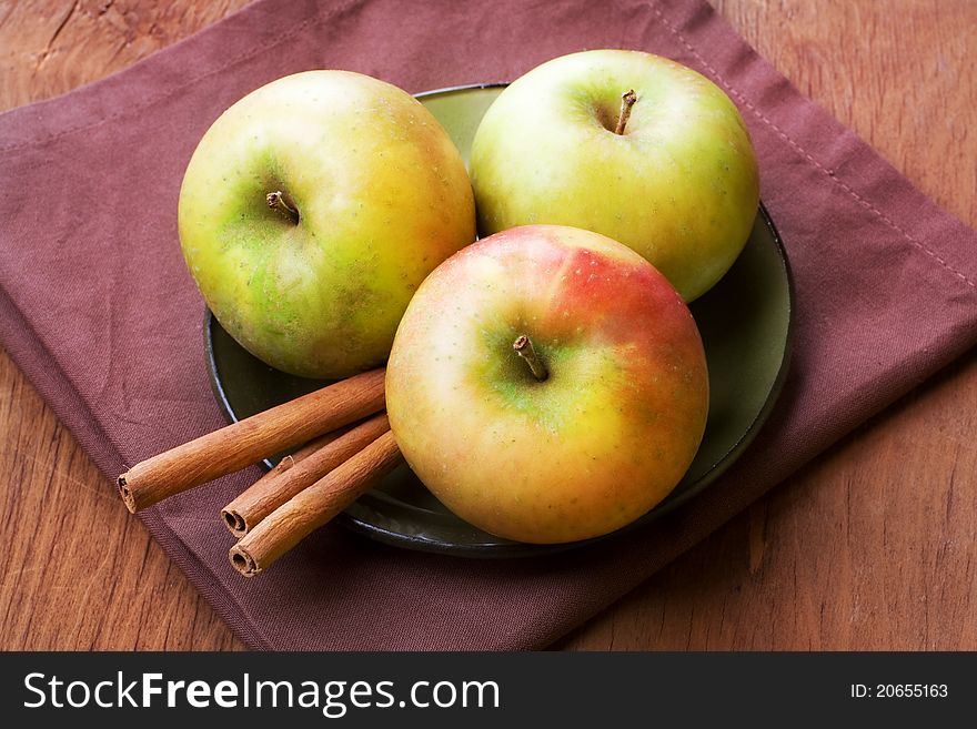 Apples and cinnamon sticks on table, still life. Apples and cinnamon sticks on table, still life.