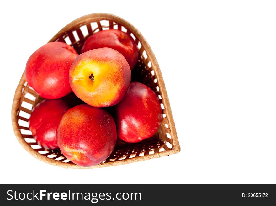Peaches on a white background in the basket