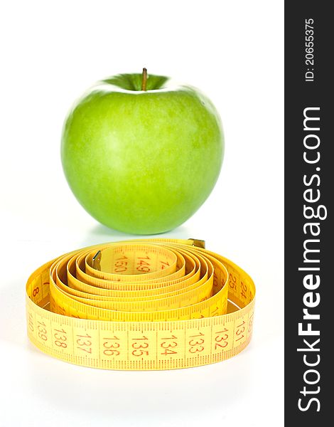 Tape measure and an apple isolated on a white background. Tape measure and an apple isolated on a white background