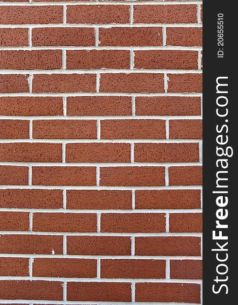 A newly built brick wall with white lines and spongy bricks. A newly built brick wall with white lines and spongy bricks