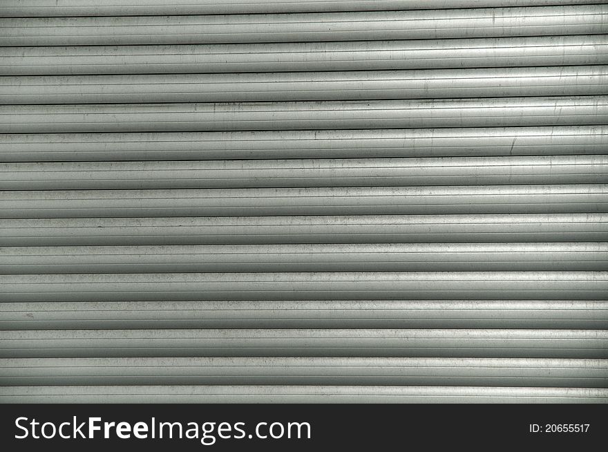 Grey colored lines of a shop's closed shutters. Grey colored lines of a shop's closed shutters