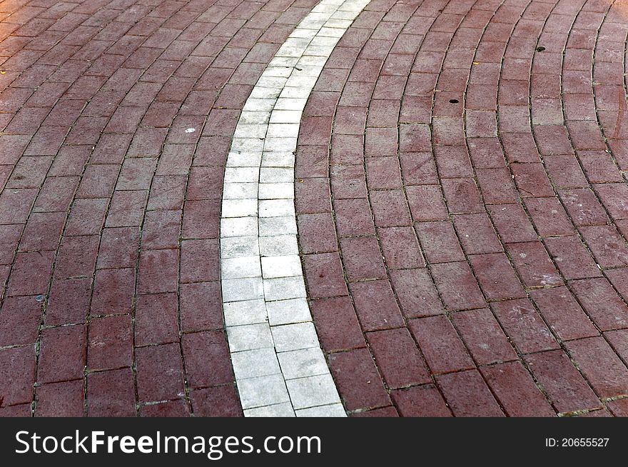 Ground mosaic at the outdoor with white and light maroon colored pattern. Ground mosaic at the outdoor with white and light maroon colored pattern