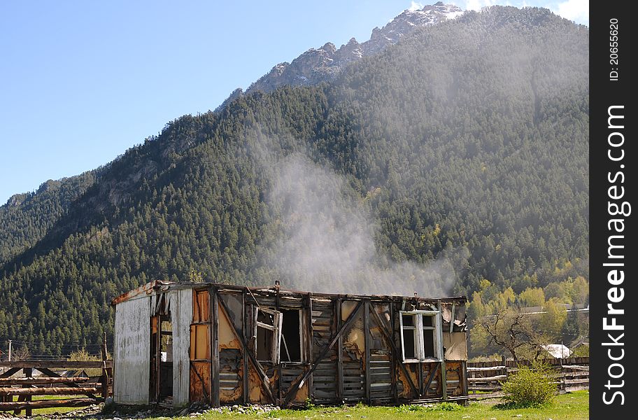 Burning ruins of the house in the mountains. Burning ruins of the house in the mountains