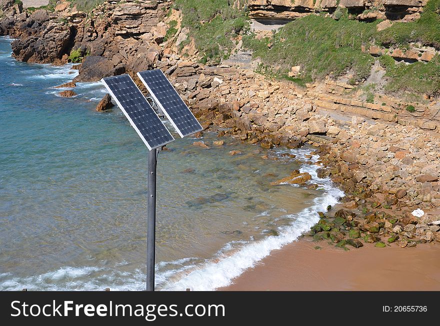 An streetlight with solar panel against coast background