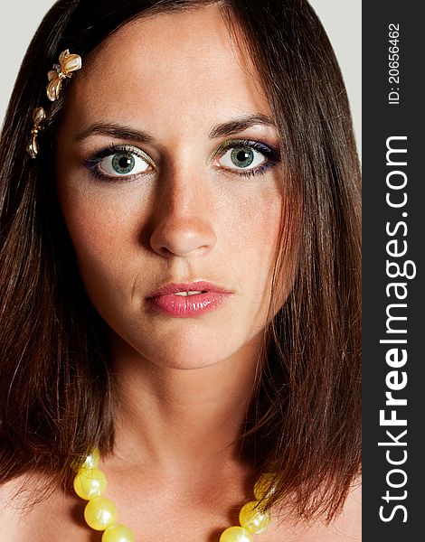 Portrait of beautiful young woman with grey eyes