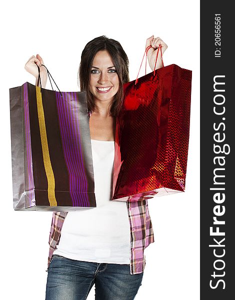 Young woman holding shopping bags on white