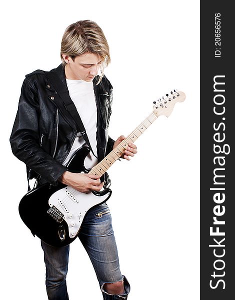 Young guy in leather jacket playing electric guitar