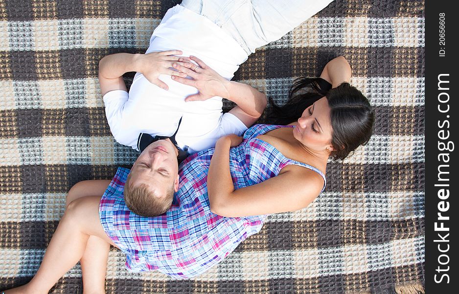 Happy young couple expecting a baby in park