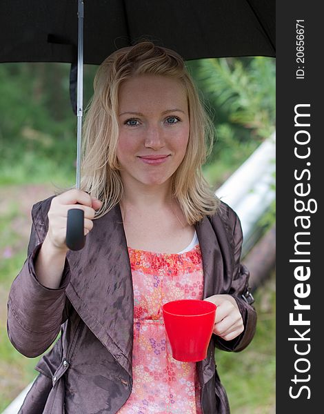 Portrait of a girl with an umbrella and tea