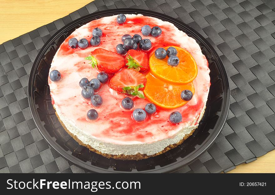 A delicious looking cheese cake with
strawberrys and berries