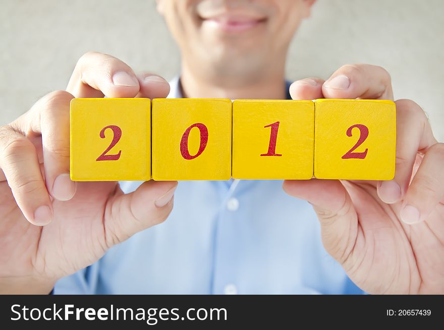 Salesman holding building blocks, building blocks that read 2012, Representatives for the 2012 years. Salesman holding building blocks, building blocks that read 2012, Representatives for the 2012 years