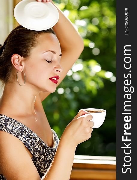 A Young Attractive Woman With A Cup Of Coffe