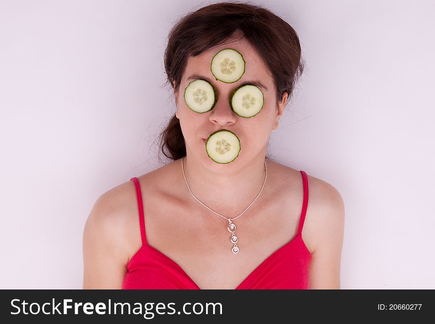 The pretty young woman with a cucumber mask. The pretty young woman with a cucumber mask