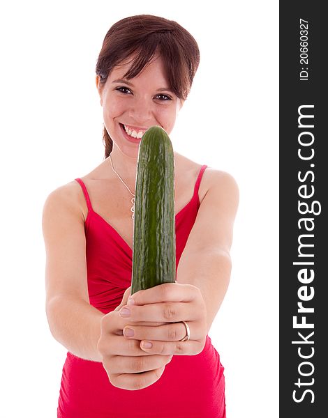 The pretty young woman holding a cucumber in his hand. The pretty young woman holding a cucumber in his hand