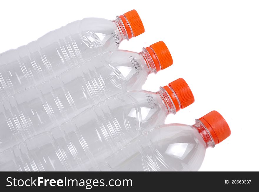 Four closed plastic bottles isolated on white background