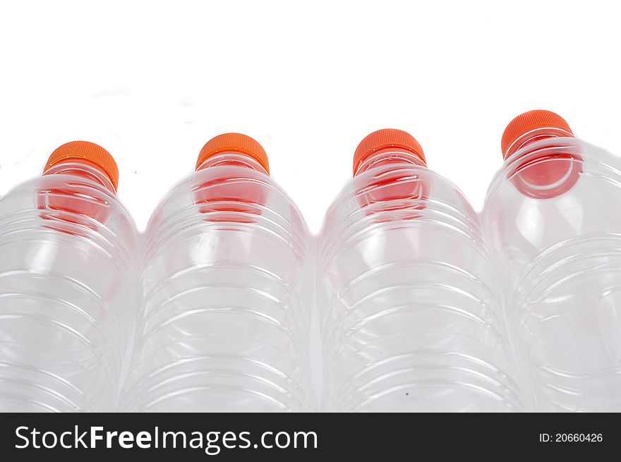 Four closed plastic bottles isolated on white background