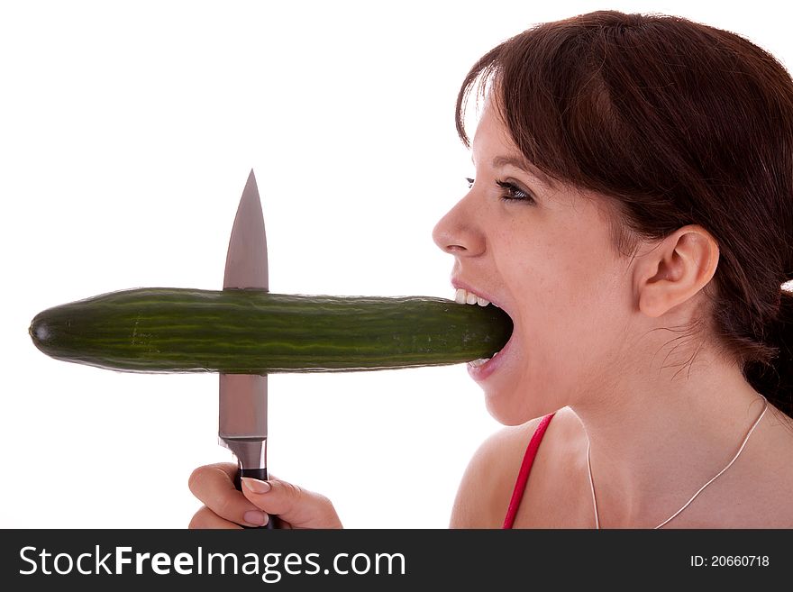 The pretty young woman has impaled a cucumber. The pretty young woman has impaled a cucumber