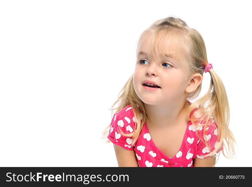 Adorable young girl with pigtails and blond hair looks to her right in studio, isolated on white. Adorable young girl with pigtails and blond hair looks to her right in studio, isolated on white.