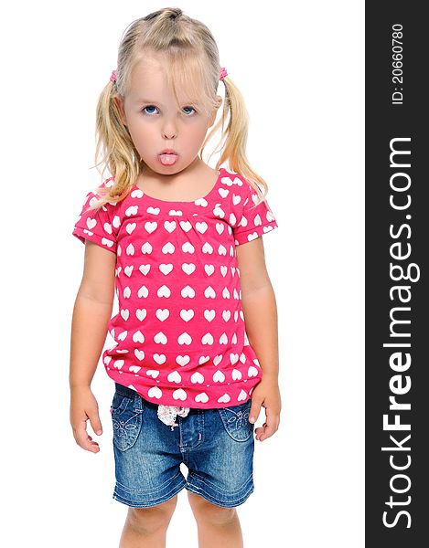 Young girl sticks out tongue while isolated on white in studio. Young girl sticks out tongue while isolated on white in studio