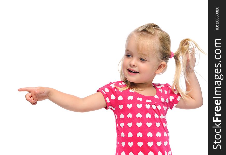 Cute blonde girl with pigtails points in a direction, isolated on white in studio. Cute blonde girl with pigtails points in a direction, isolated on white in studio